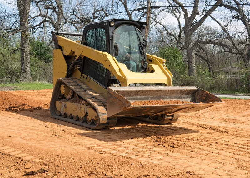 Skid-steer grading and preparing a site for paving